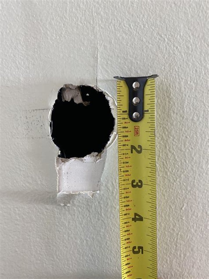How do you cut a round hole in drywall?