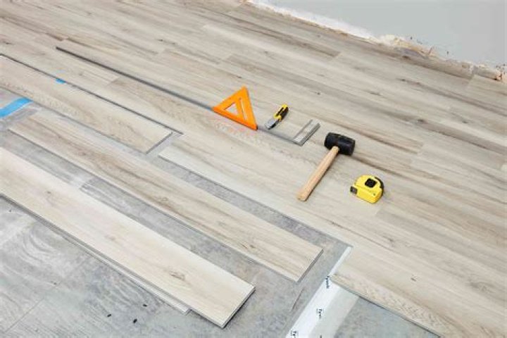 How do you flatten vinyl flooring?