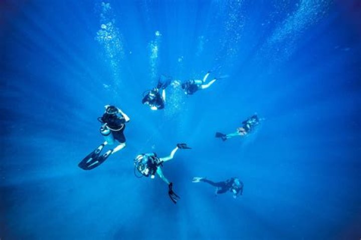 How do you get into the water when scuba diving?
