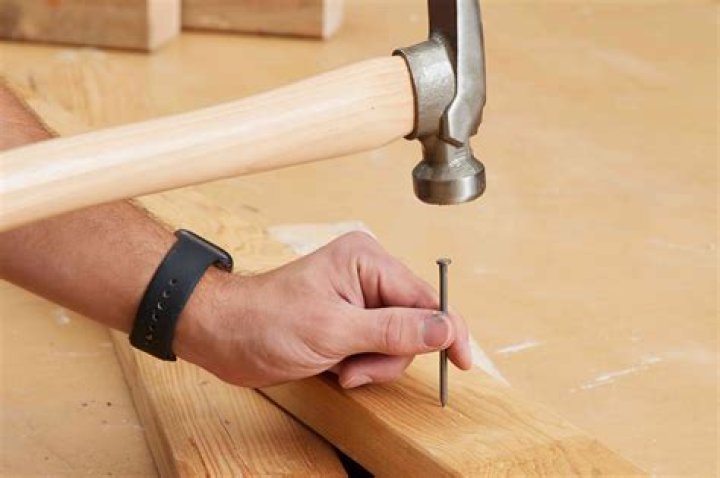 How do you hammer baseboard nails?