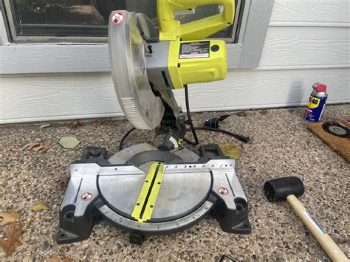 How do you lift a Ryobi miter saw?