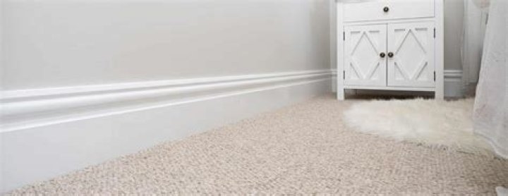 How do you paint skirting boards with carpet?