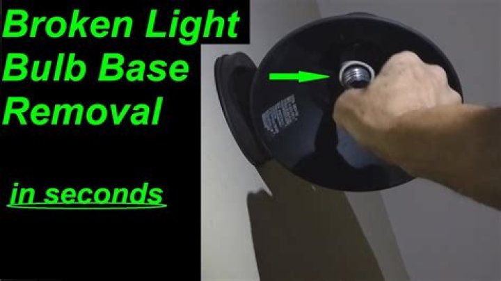 How do you remove a broken light bulb from the base?