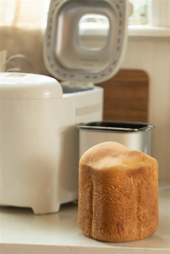How do you remove a loaf from a bread maker?