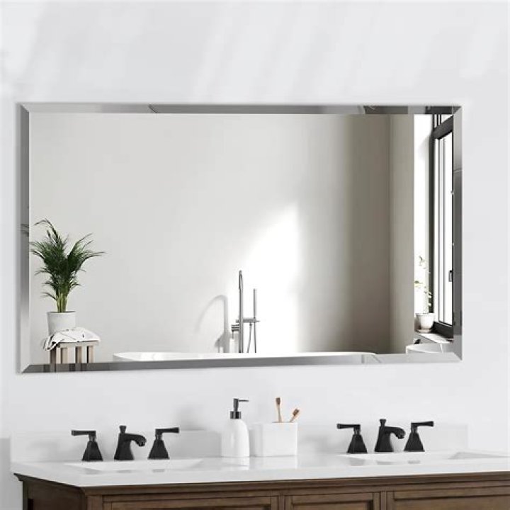 How do you secure a bathroom mirror to the wall?