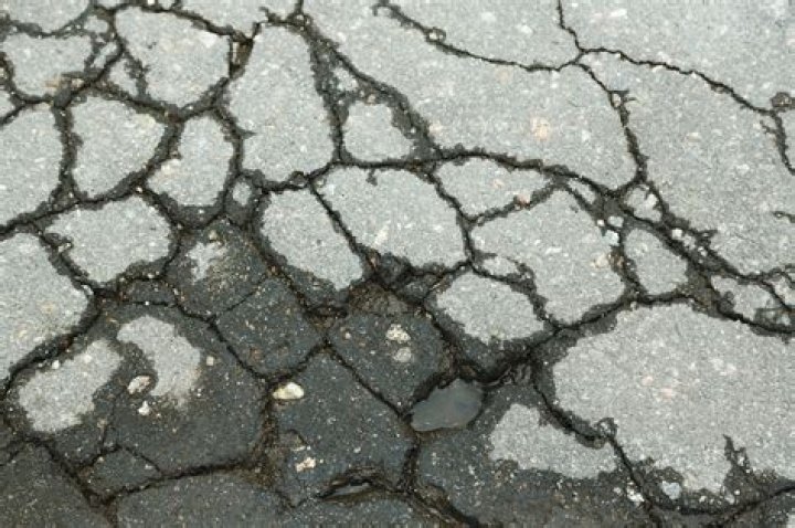 What causes cracks in asphalt?