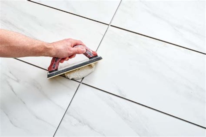 What is the correct way to mix grout?