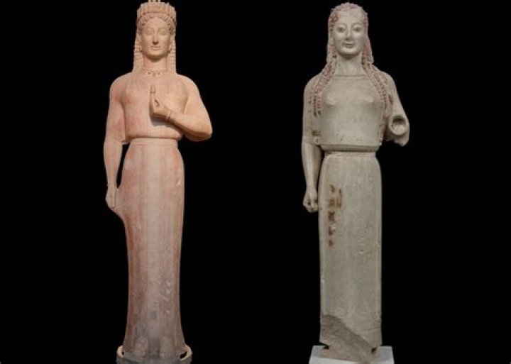 What purpose are kouros sculptures believed to have served?